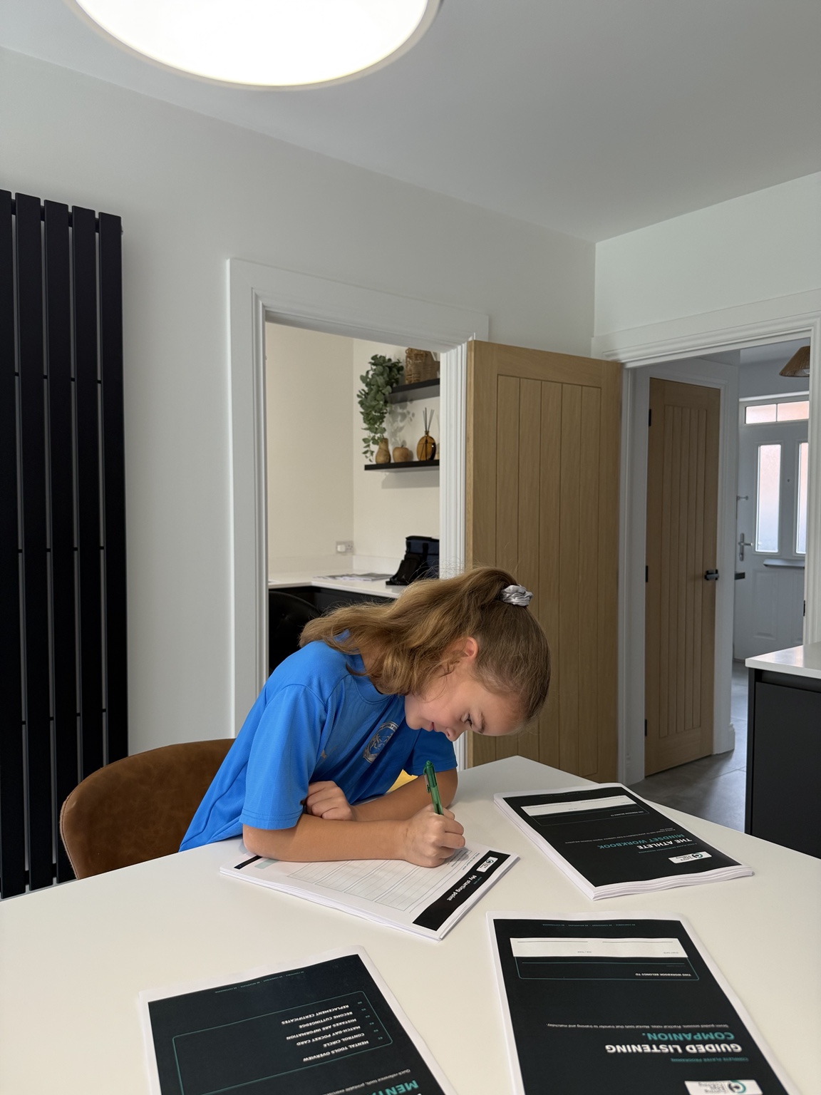 Young CuttingEdge athlete working through her mindset workbook at home